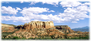 Beautiful rock formations and puffy white clouds comprise the scenery in Abiquiu, New Mexico.